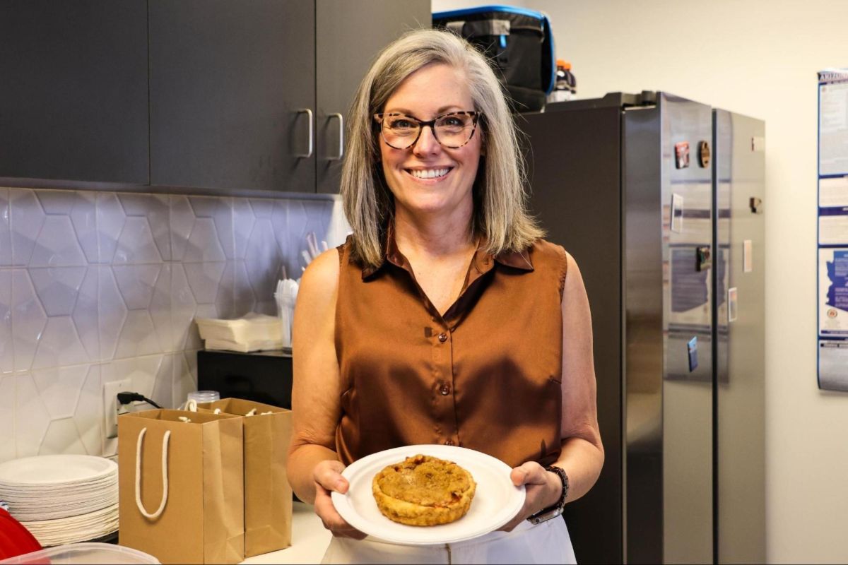 Katie Hobbs holding her homemade peach tart